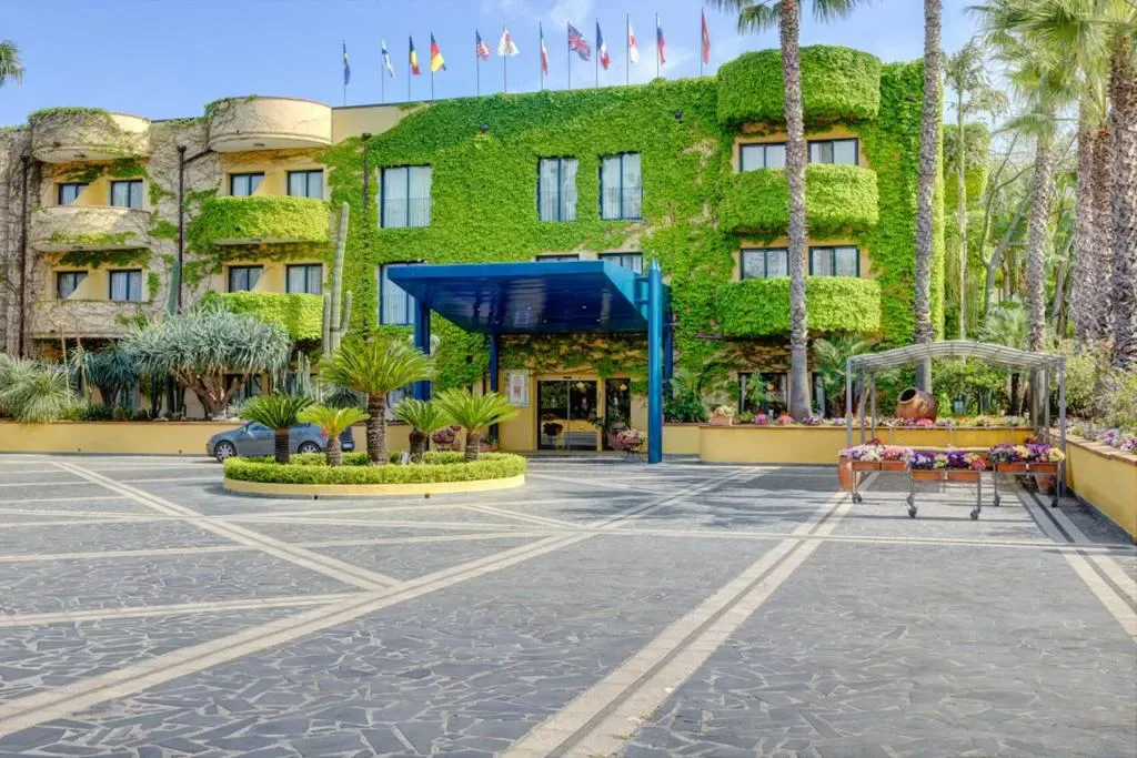 Hotel Caesar Palace exterior with pool in Giardini Naxos, Sicily